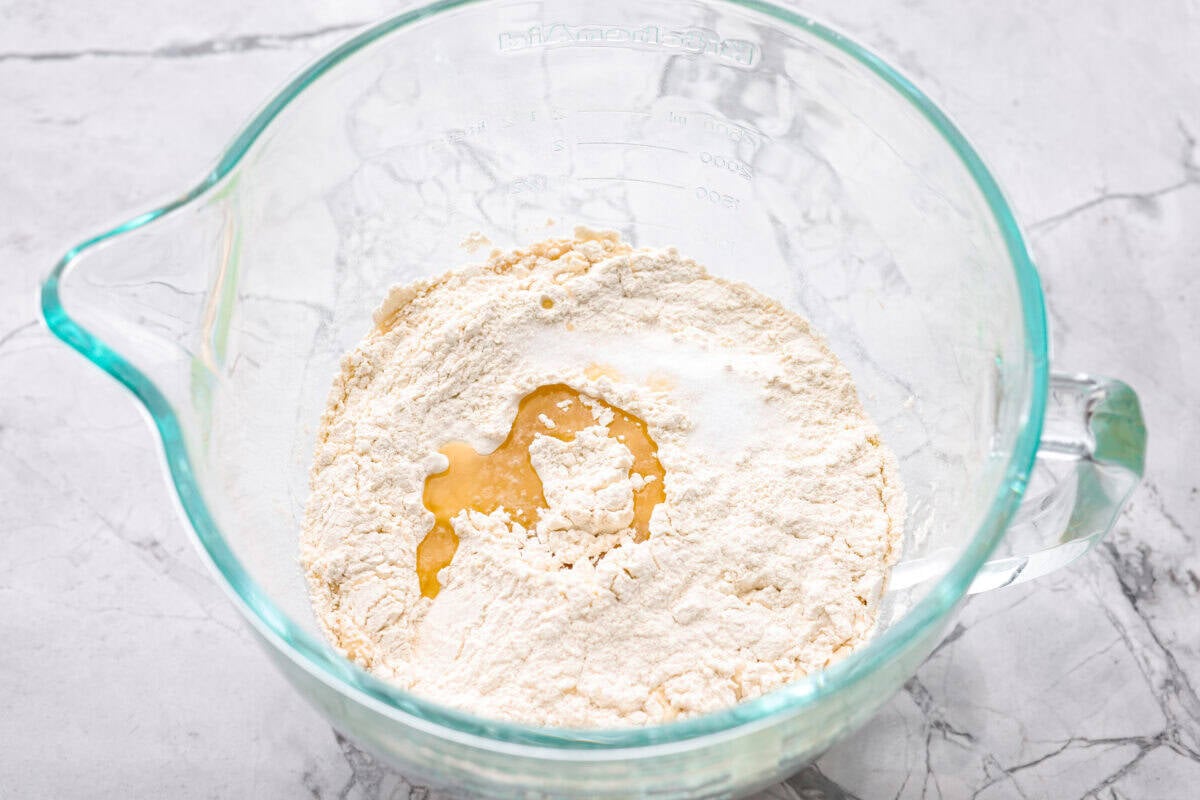 Flour, olive oil and salt added to the yeast mixture. 