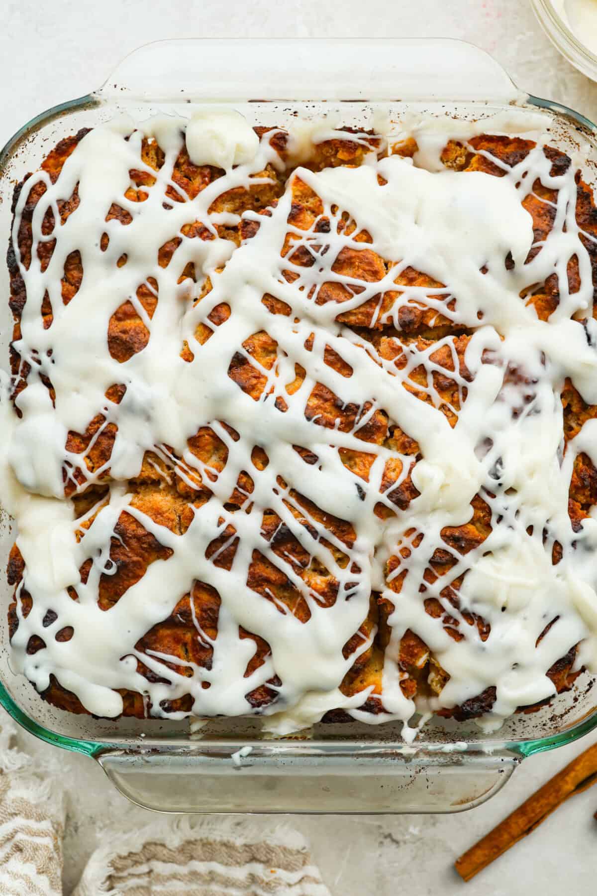 These cinnamon roll butter swim biscuits are my cheat code to making "cinnamon rolls." They bake up soft and fluffy with a sweet cinnamon swirl and icing on top. They disappear almost as fast as you can make them! Pan of cinnamon roll butter swim biscuits baked, iced and ready to eat.