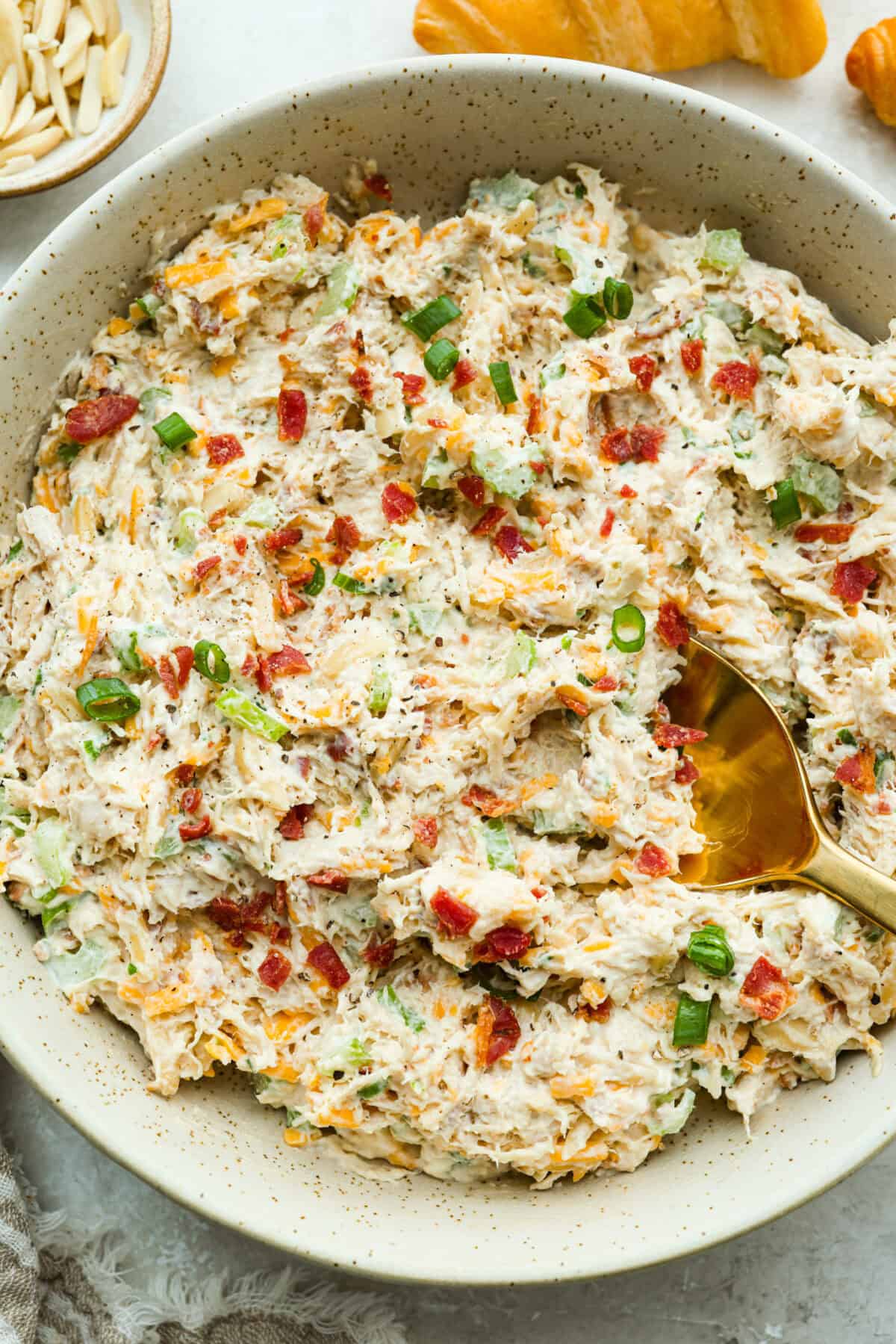 Million dollar chicken salad totally lives up to the name. It’s creamy, cheesy, crunchy, and packed with bacon, so every bite is full of flavor. Serve it on croissants, with crackers, or straight from the bowl! It's that good. Large bowl of million dollar chicken salad ready to be eaten.