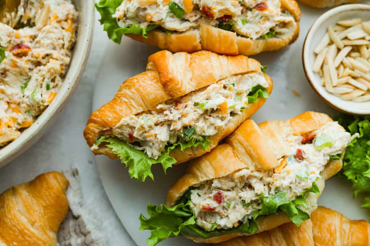 Million dollar chicken salad totally lives up to the name. It’s creamy, cheesy, crunchy, and packed with bacon, so every bite is full of flavor. Serve it on croissants, with crackers, or straight from the bowl! It's that good. Million dollar chicken salad in croissants with lettuce.