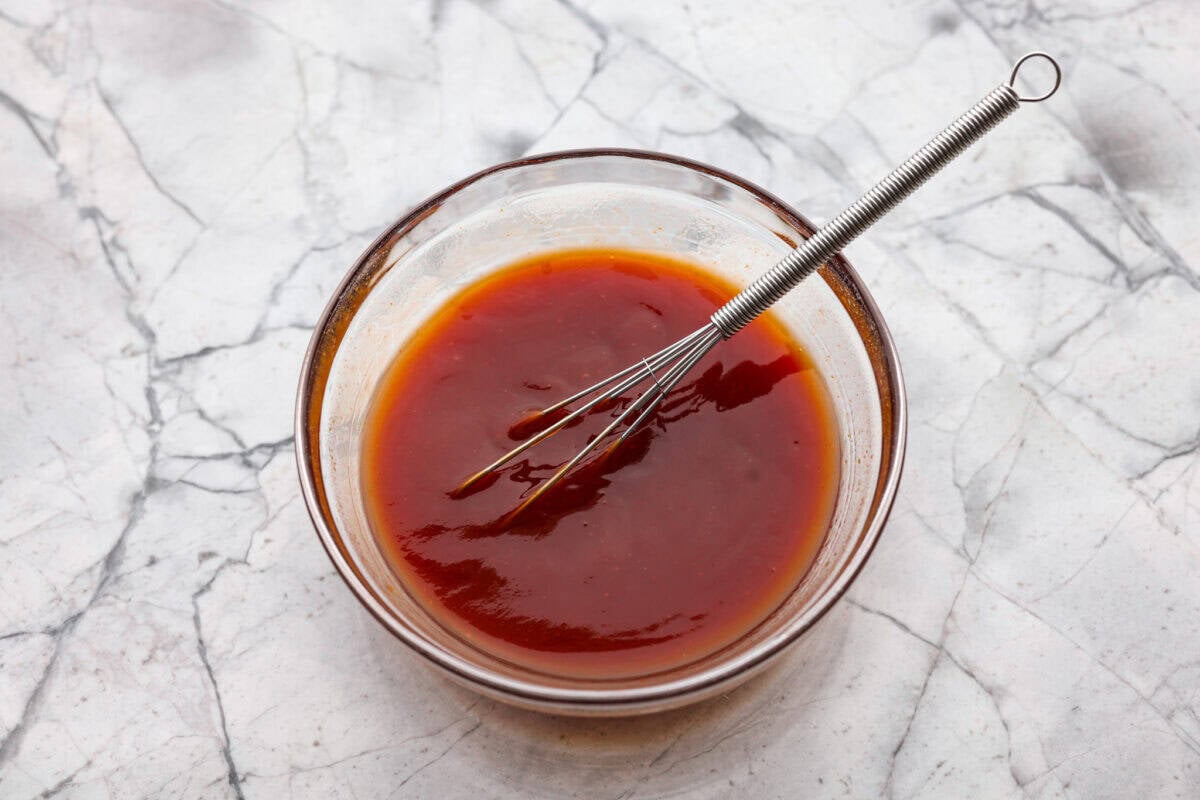 Meatloaf is even better in mini form! These mini meatloaf muffins are tender, flavorful, and topped with a sweet, tangy glaze. They are done in about 25 minutes, making them perfect for an easy dinner I know the kids will love. Sauce ingredients added to a bowl.