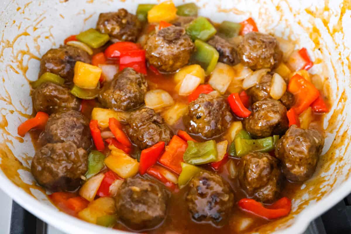 These sweet and sour meatballs are one of those dinners I pull out when I need something easy, but I know everyone likes! They’re saucy, a little sweet, a little tangy, and come together fast. Sauce and sweet and sour meatballs ingredients all combined in a skillet.