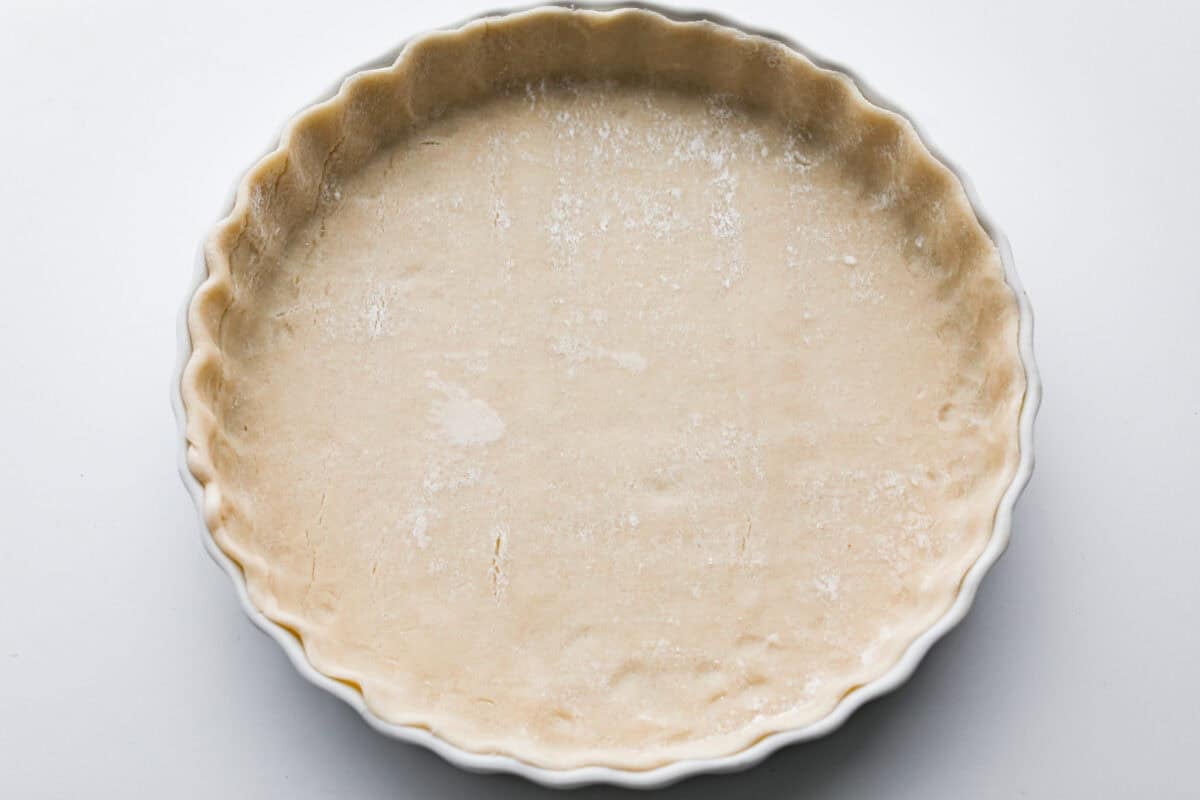 Pie crust in the bottom of a pie dish. 