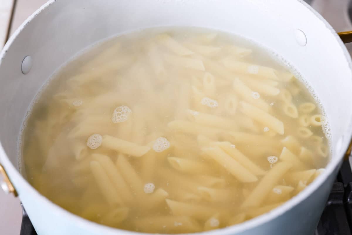 Pasta being cooked in water. 