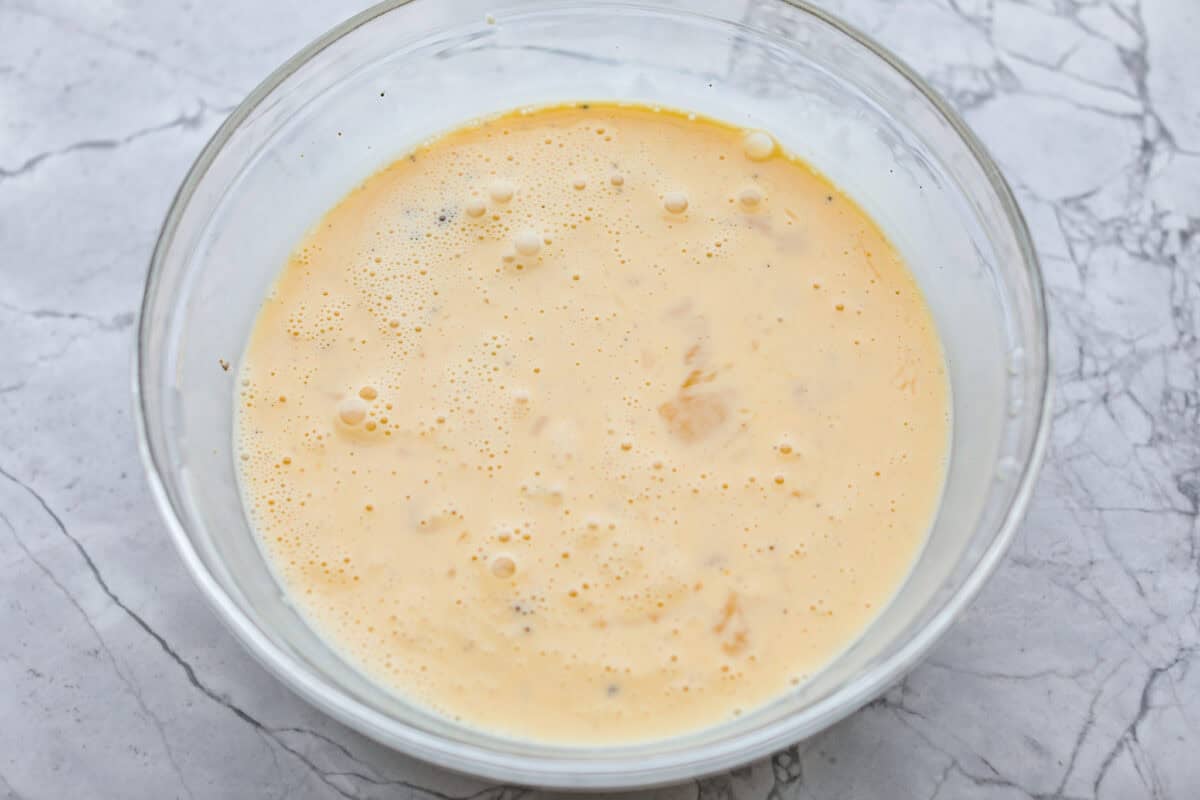 This farmer's casserole is my answer to summer mornings when the kids want cereal again, but I want them to eat something that will actually keep them full. Itโs packed with protein, and it's easy to customize with fresh garden veggies. Egg mixture all whisked together in a bowl.