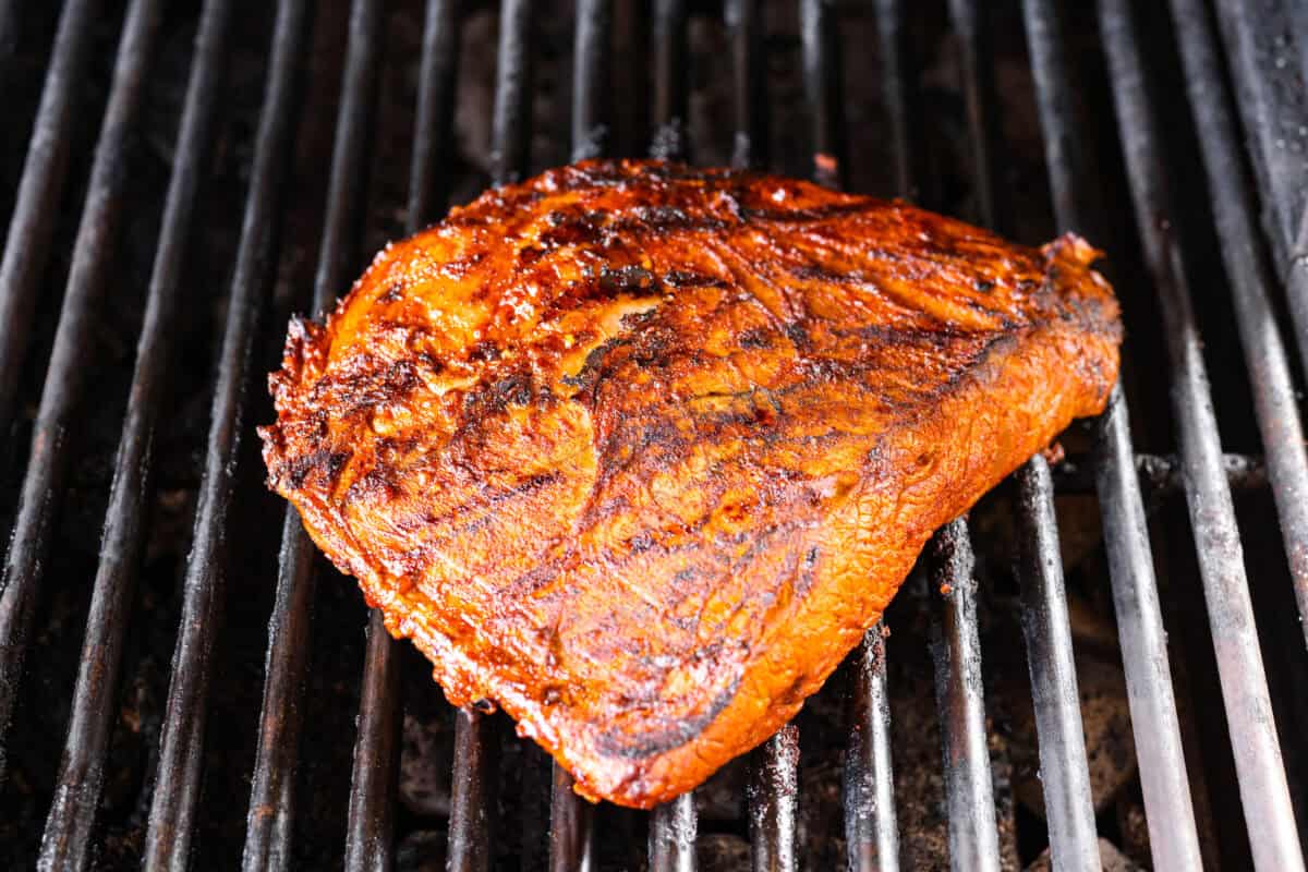 Grilled steak fajitas are one of those dinners that feels fun the second it hit the table. The steak is juicy and smoky, the peppers and onions are tender and flavorful, and everyone gets to build their fajitas just the way they like them. Marinated steak cooking on the grill.