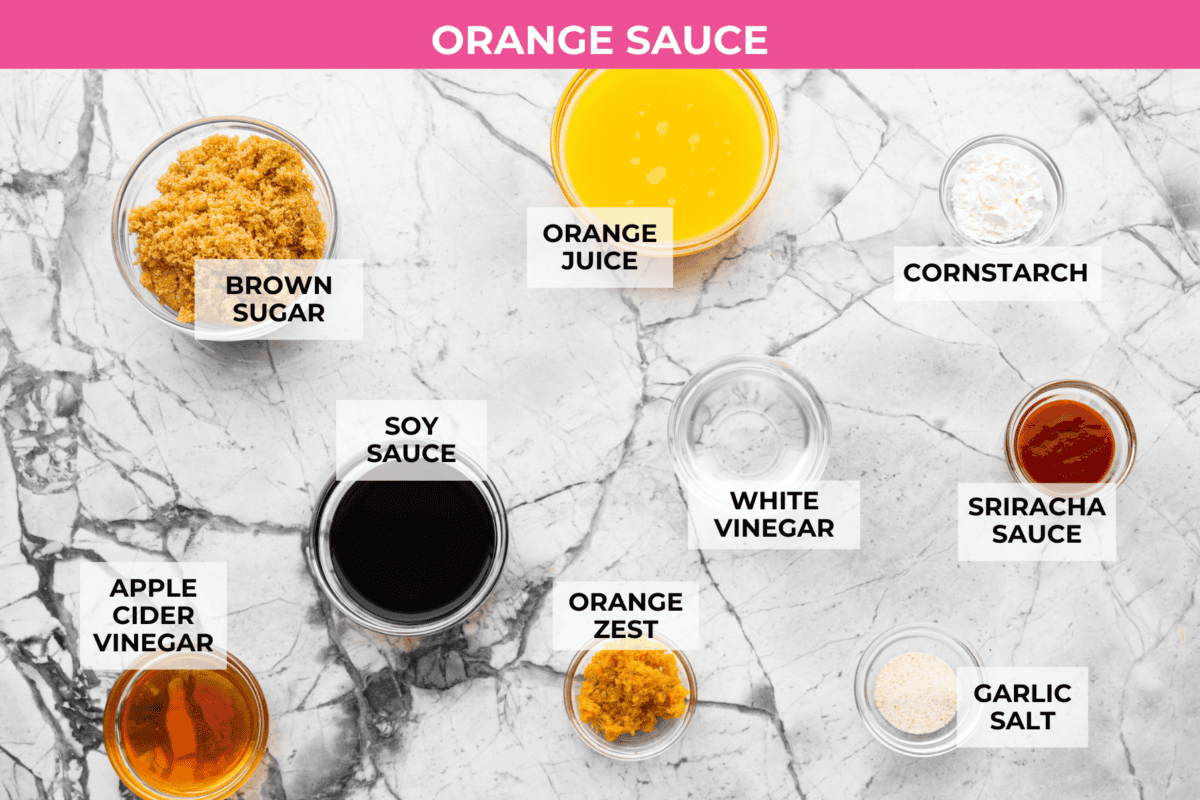 Baked orange chicken is sweet, tangy, and coated in the best sticky orange sauce. It has all the flavor of your favorite takeout, but itโs made right at home and baked until the chicken is perfectly tender. Overhead shot of labeled sauce ingredients.