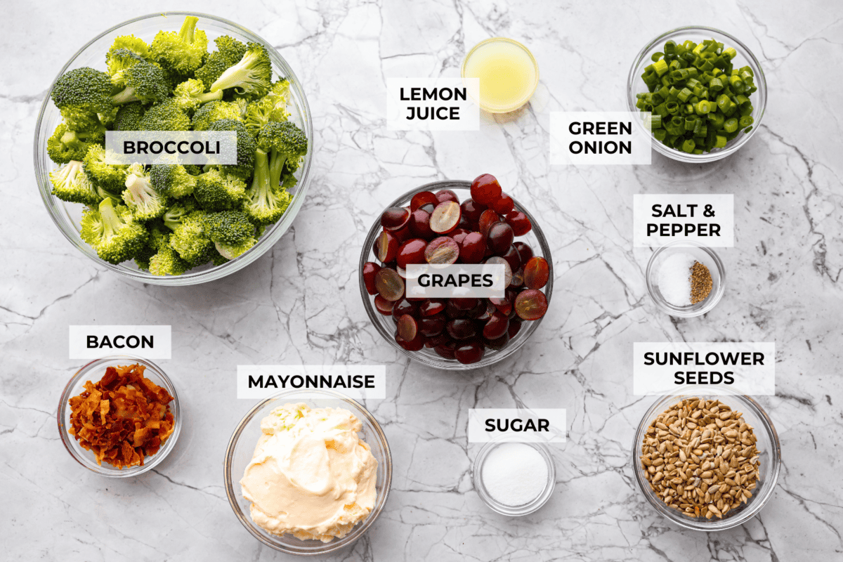 Overhead shot of labeled broccoli grape salad ingredients. 