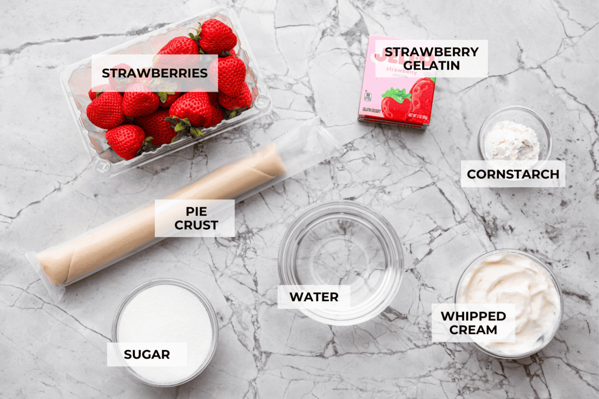 My fresh strawberry pie is one of those desserts that looks gorgeous but is so easy to make. A premade pie crust, juicy, fresh strawberries, and a quick homemade glaze come together to make a glossy, beautiful pie! Overhead shot of labeled ingredients.