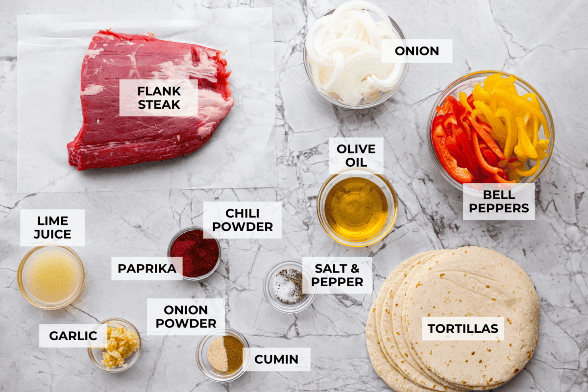 Grilled steak fajitas are one of those dinners that feels fun the second it hit the table. The steak is juicy and smoky, the peppers and onions are tender and flavorful, and everyone gets to build their fajitas just the way they like them. Overhead shot of labeled ingredients.