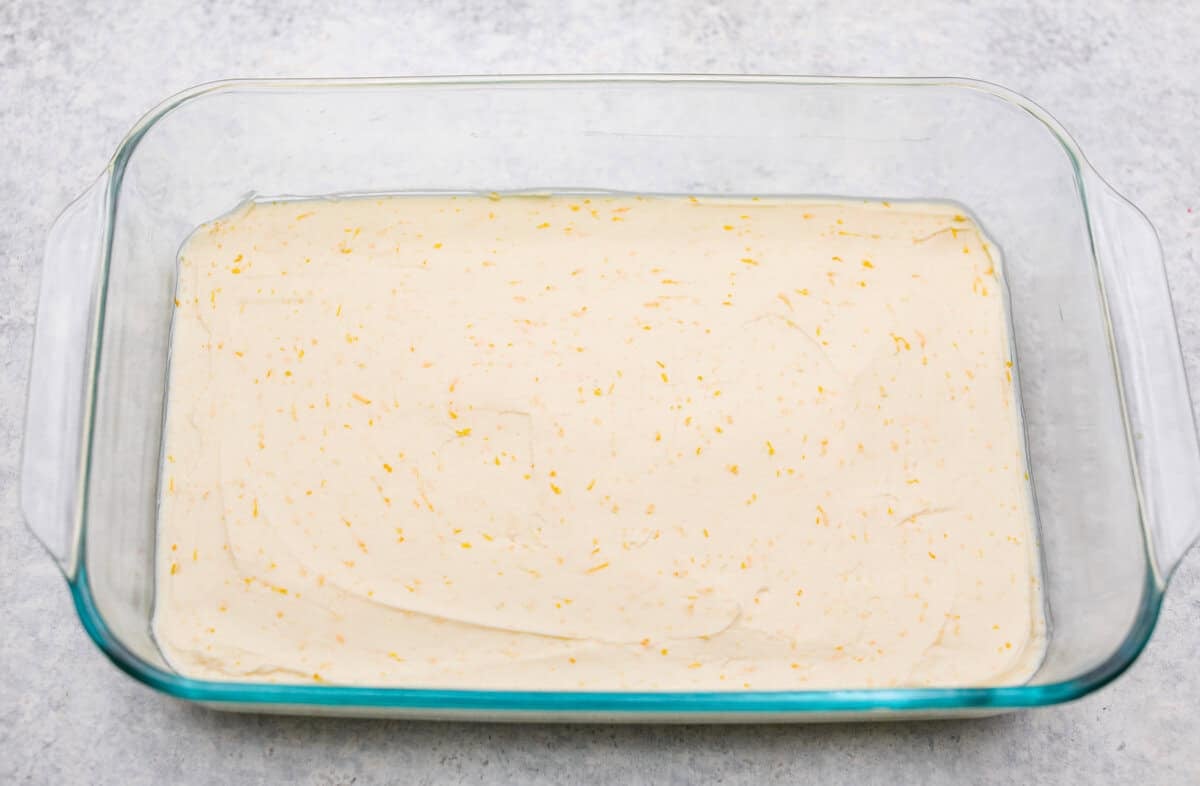 Orange creamsicle lush is sunshine in dessert form! With creamy orange layers, a buttery golden Oreo crust, and bright fresh citrus flavor, this easy no-bake dessert is a fun twist on my popular Lemon Lush that’s perfect for summer. Cream cheese mixture in the bottom of the 9x13 dish.