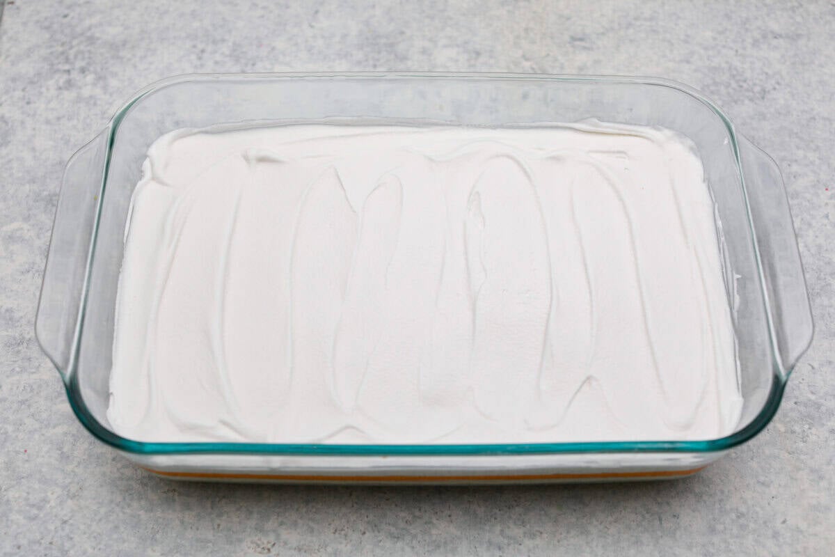 Whipped topping layer on top of the orange layers. 