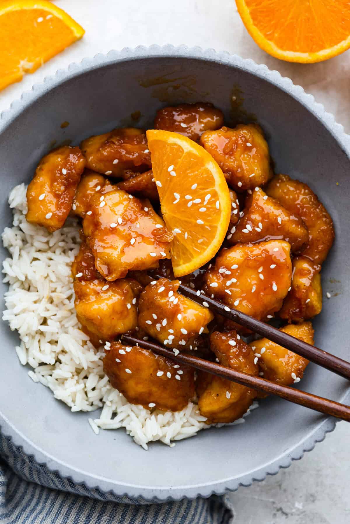https://therecipecritic.com/baked-orange-chicken/ Bowl of rice and baked orange chicken.