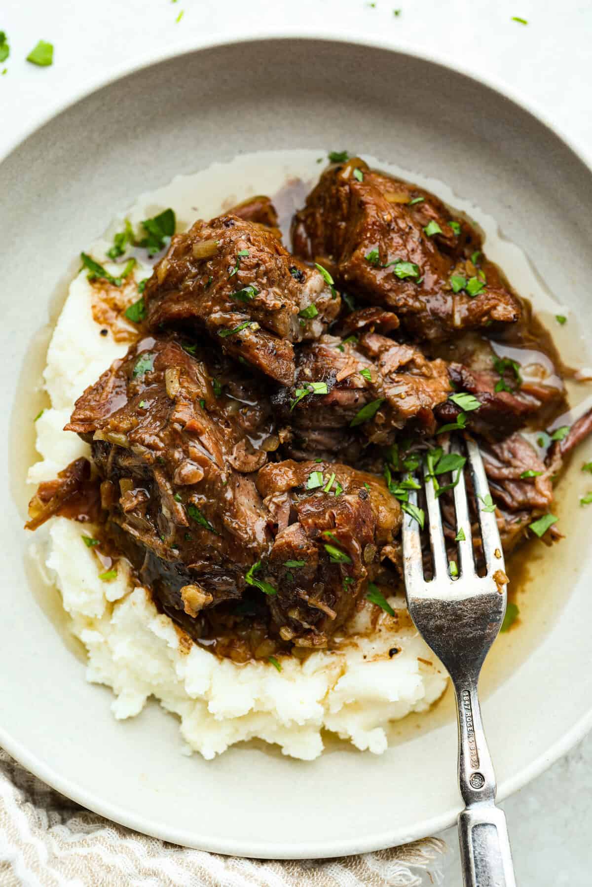 Cook the roast low and slow until tender, j 3-Ingredient Buttered Beef Topped Mashed Potatoes Dish.