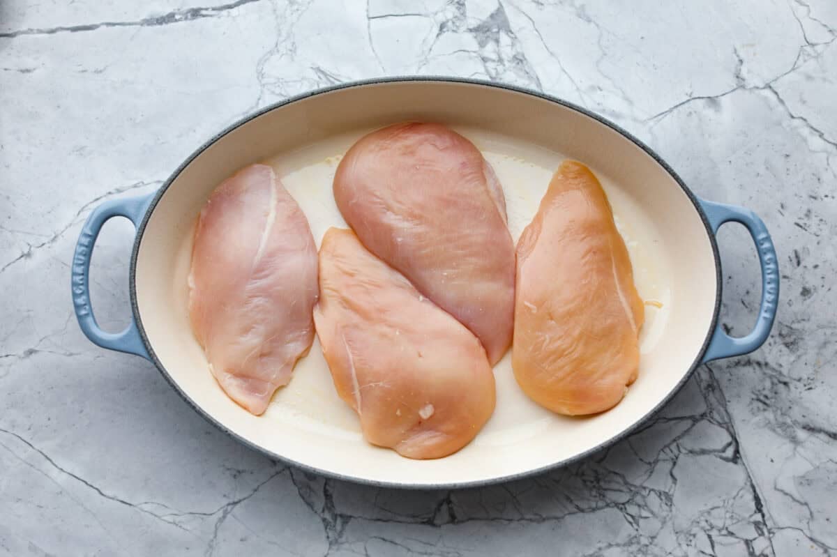 Chicken breasts in the bottom of the baking dish. 
