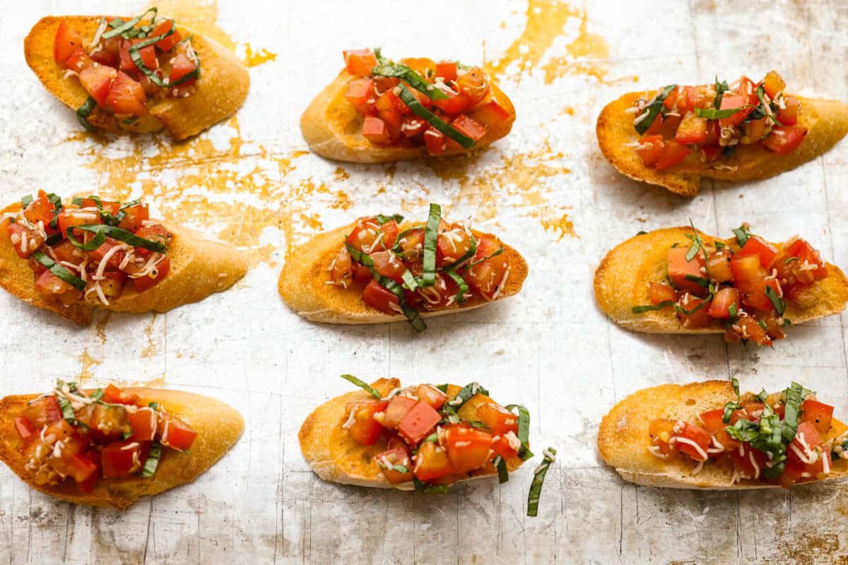 Iโve loved homegrown tomatoes since I was a kid, and this easy bruschetta recipe is one of my favorite ways to use them. The fresh basil, garlic, olive oil, and crispy toasted bread with that balsamic glaze make such a good flavor! Tomato topping added to the tops of the toasted bread.