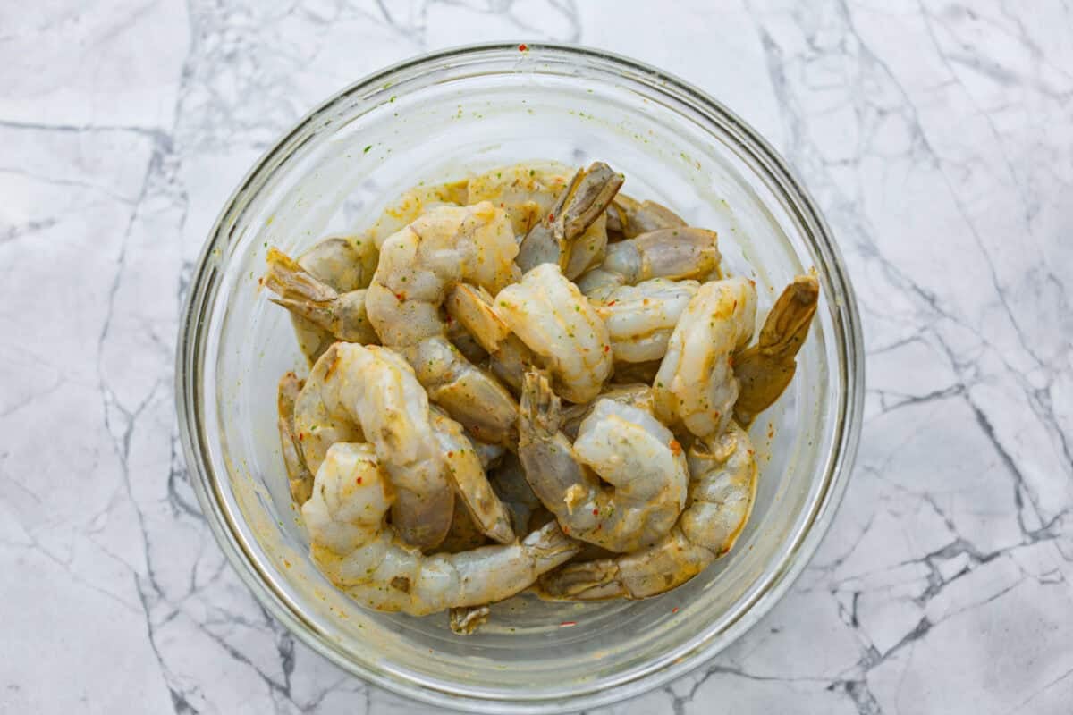 I love salads in the summer, and this grilled shrimp salad is such a good one. It’s fresh, colorful, and filling without feeling heavy. And the dressing? Oh my gosh. The chipotle-lime flavor is so good, you’ll want to pour it on everything. Raw shrimp in a bowl covered in the dressing as a marinade.