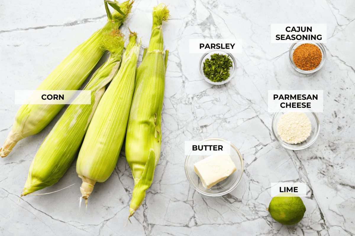 You already know I love a good corn recipe, and this Cajun corn on the cob is my new summer BBQ obsession. It takes sweet, juicy corn and gives it the buttery, spicy glow-up it deserves. Overhead shot of labeled ingredients.