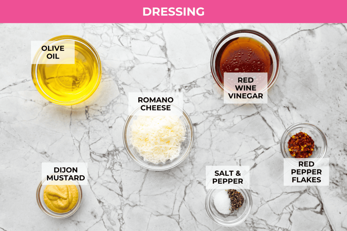 This copycat La Scala Salad is the famous Italian chopped salad from Beverly Hills that Kim Kardashian is rumored to love. Itโs fresh, crunchy, and packed with chickpeas, salami, mozzarella, and zesty red wine vinaigrette. Overhead shot of labeled dressing ingredients.