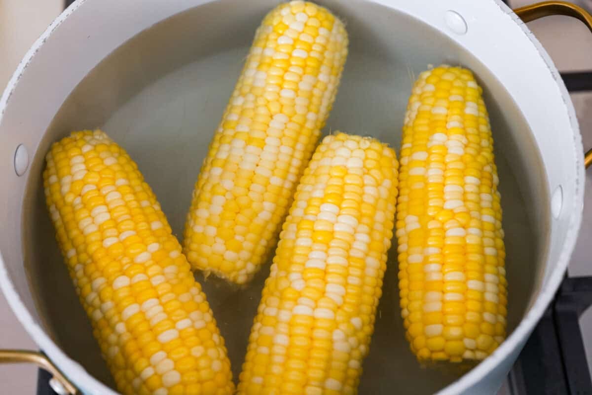 You already know I love a good corn recipe, and this Cajun corn on the cob is my new summer BBQ obsession. It takes sweet, juicy corn and gives it the buttery, spicy glow-up it deserves. Corn in the pot of boiling water.