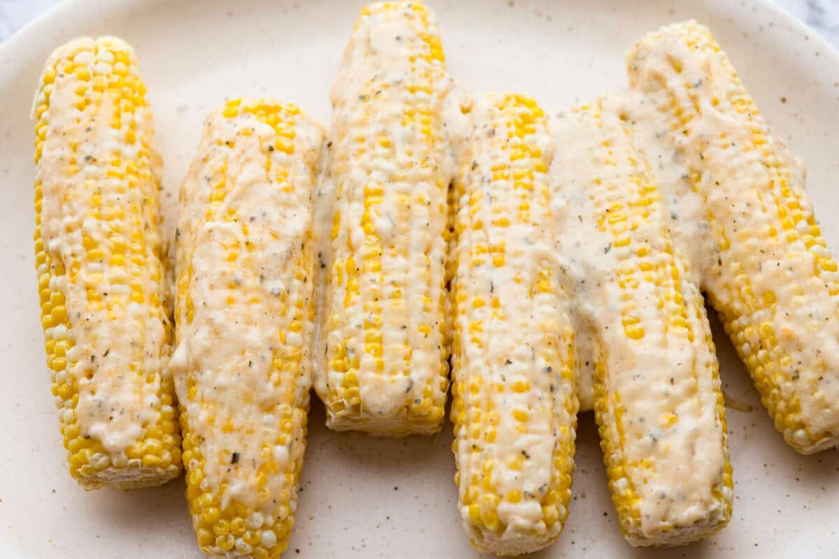 Sauce spread over the corn cobs.