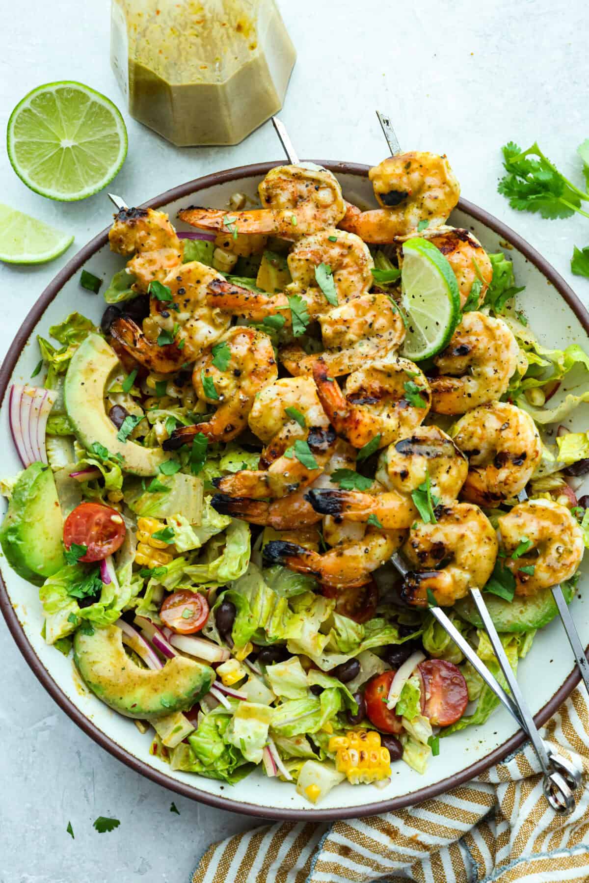 I love salads in the summer, and this grilled shrimp salad is such a good one. It’s fresh, colorful, and filling without feeling heavy. And the dressing? Oh my gosh. The chipotle-lime flavor is so good, you’ll want to pour it on everything. Large plate of grilled shrimp salad.