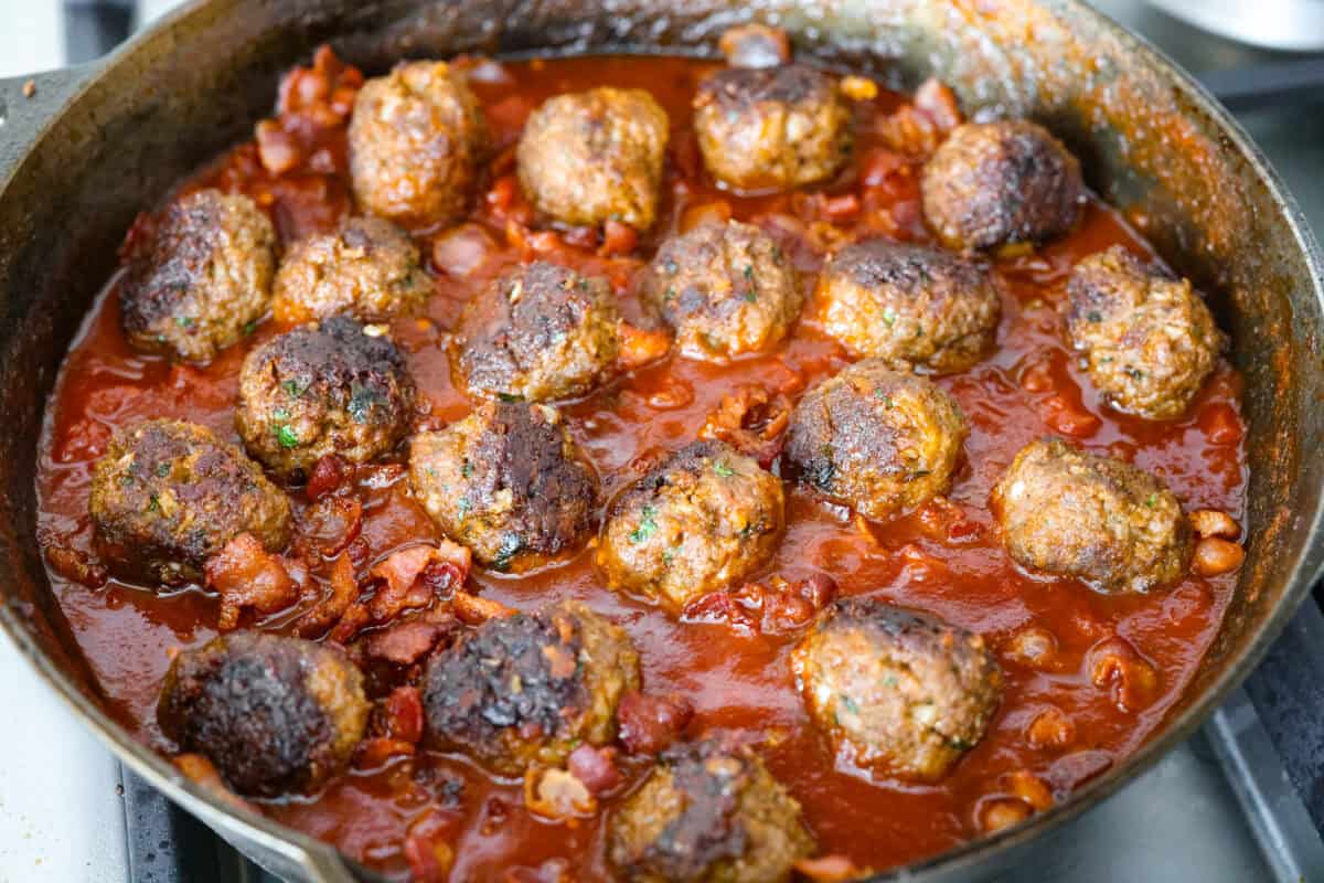 Cooked meatballs added to the cooked down sauce. 