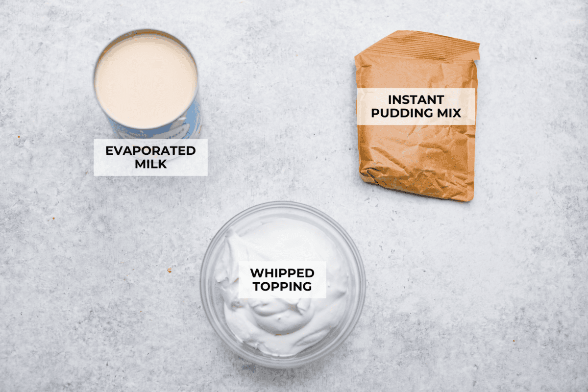 Pudding pops instantly take me back to summer as a kid! They’re cold, creamy, chocolatey, and easy to make with just a few simple ingredients. Keep a batch in the freezer for hot afternoons or an easy after-dinner treat. Overhead shot of labeled pudding pop ingredients.