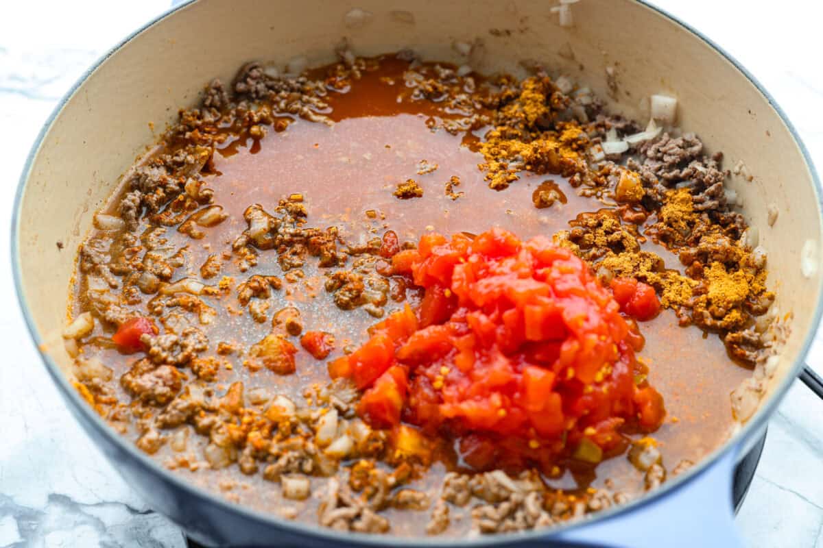 Taco mac ingrediets added to the skillet with the brown beef. 