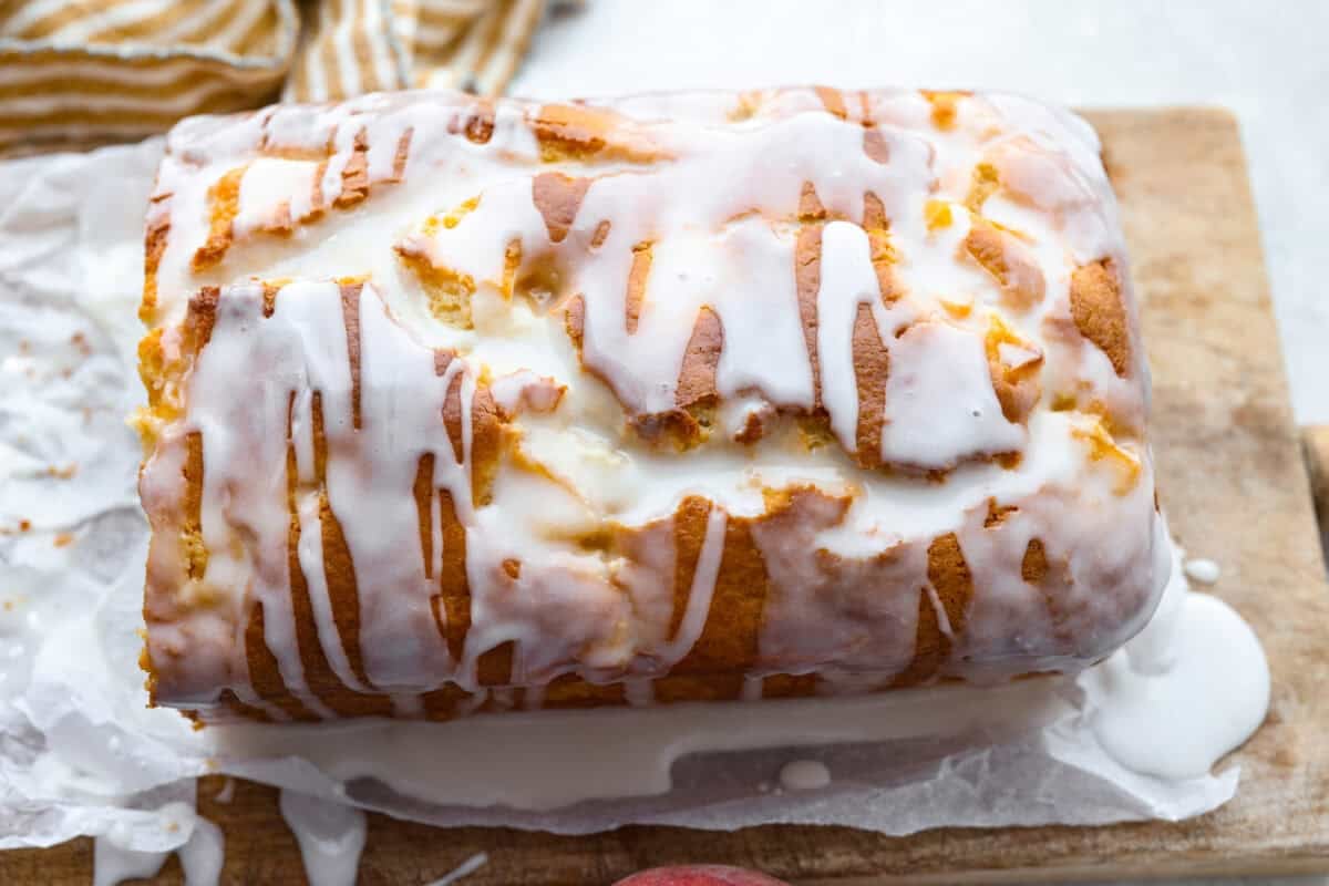 If you love peaches, this peach loaf belongs on your baking list! It’s incredibly moist, packed with sweet peaches, and topped with a peach glaze that makes every slice even more irresistible. Glaze drizzled over the top of the peach loaf.