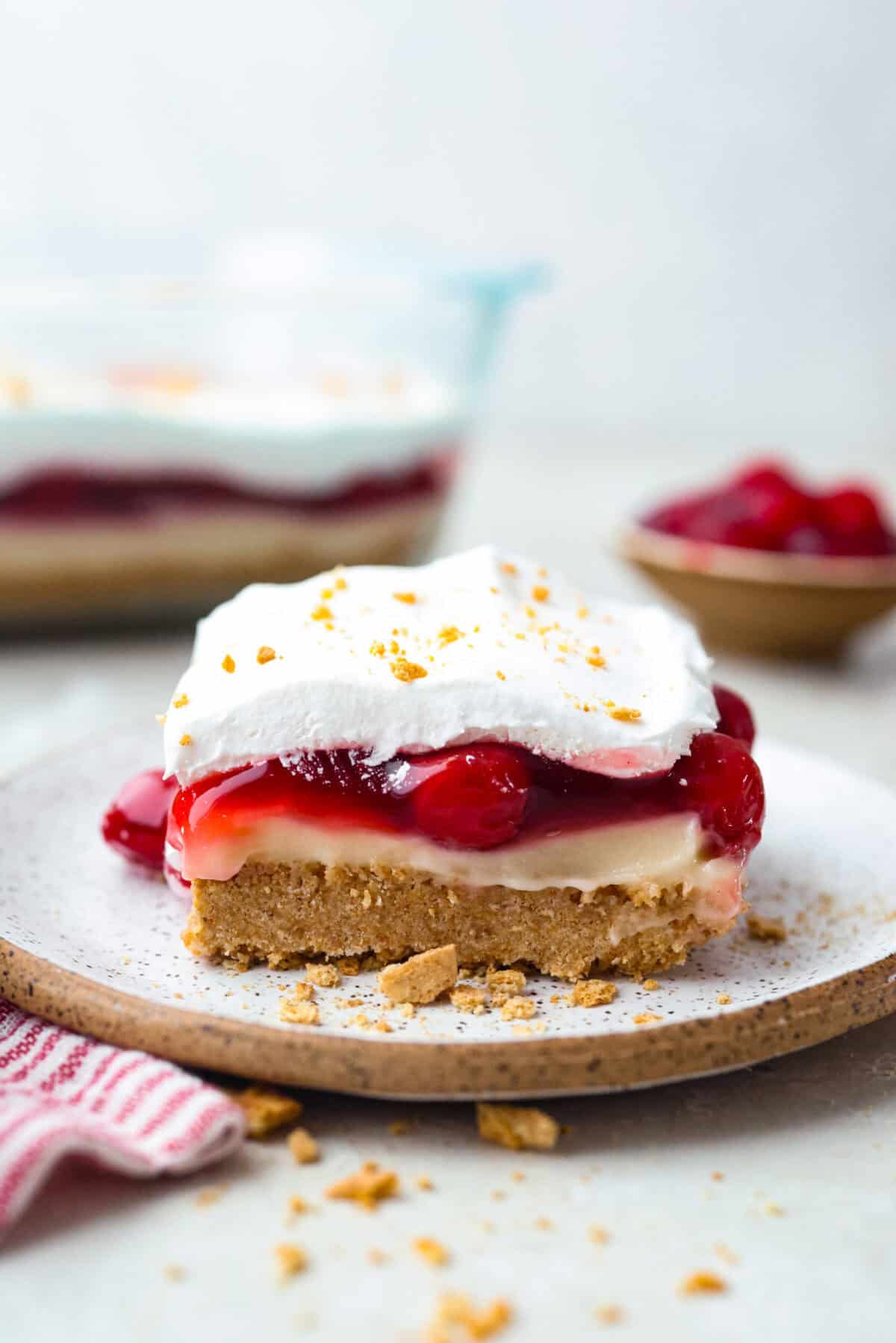 Side shot of a slice of cherry cheesecake lush. 