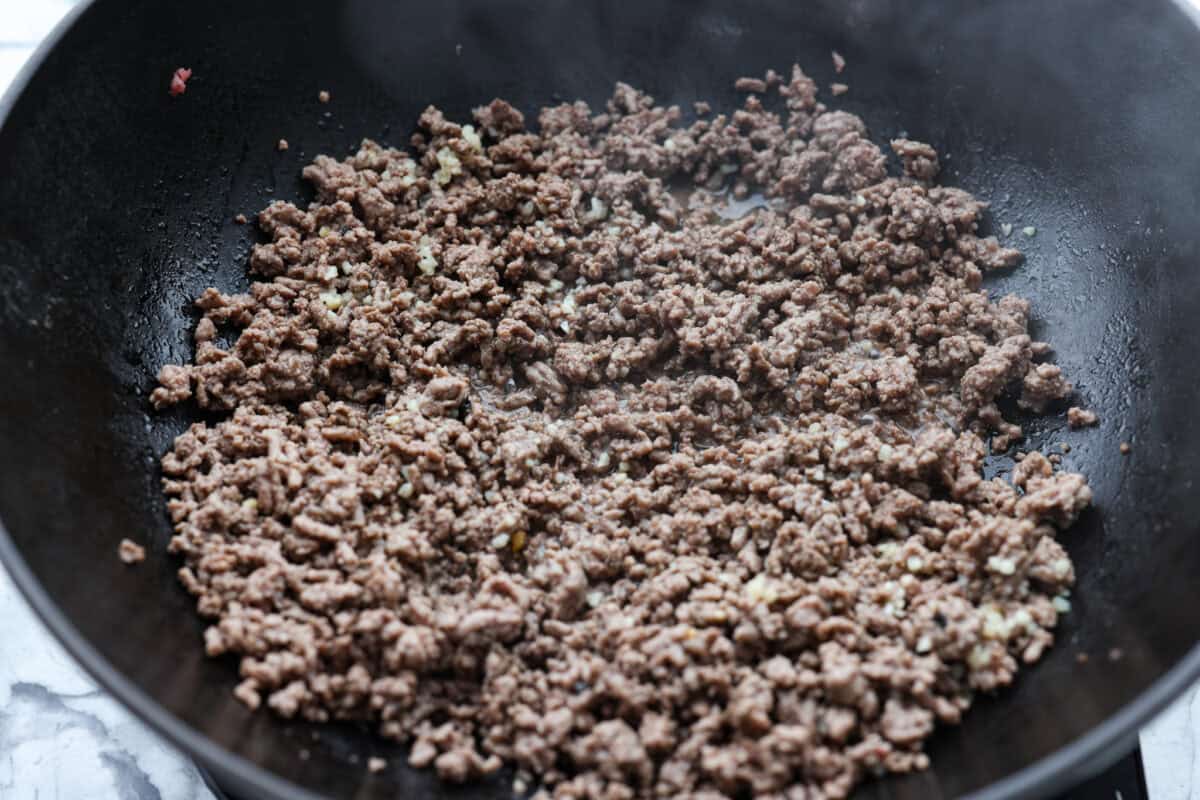 Ground beef cooking in a skillet. 