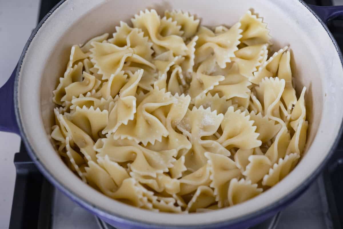 The viral crispy pasta salad trend is here, and it’s easy to see what the hype is about! Golden, crunchy pasta is tossed with fresh veggies and a creamy dressing for a fun upgrade that’s anything but boring. Cooked pasta in a pot on the stove.