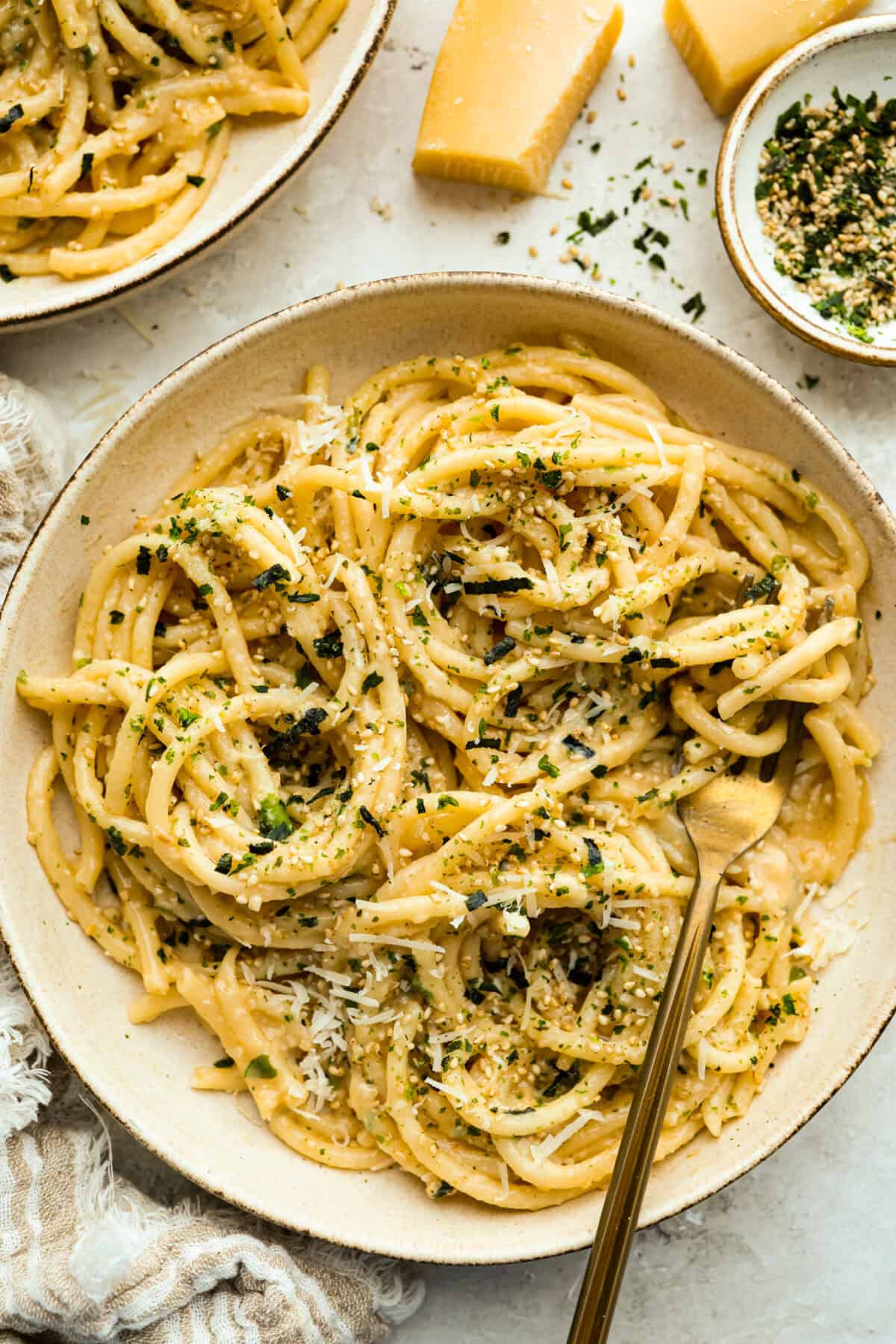My 5-ingredient miso pasta turns pantry staples into something you'd swear came from a restaurant kitchen. Butter, garlic, and miso melt together into a rich, savory sauce that clings to every strand of bucatini. Bowl of miso pasta with gold fork.