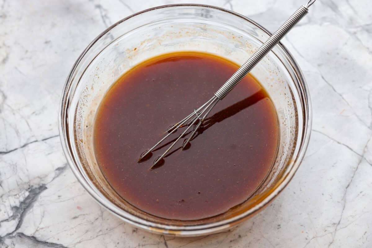 Slow cooker Aloha chicken is sweet, smoky, and so easy to throw together! Tender chicken cooks with pineapple, onion, and barbecue sauce until itβs full of flavor and ready to shred. Serve it over rice for a simple dinner the whole family will love. Slow cooker Aloha chicken sauce ingredients whisked together in a bowl.