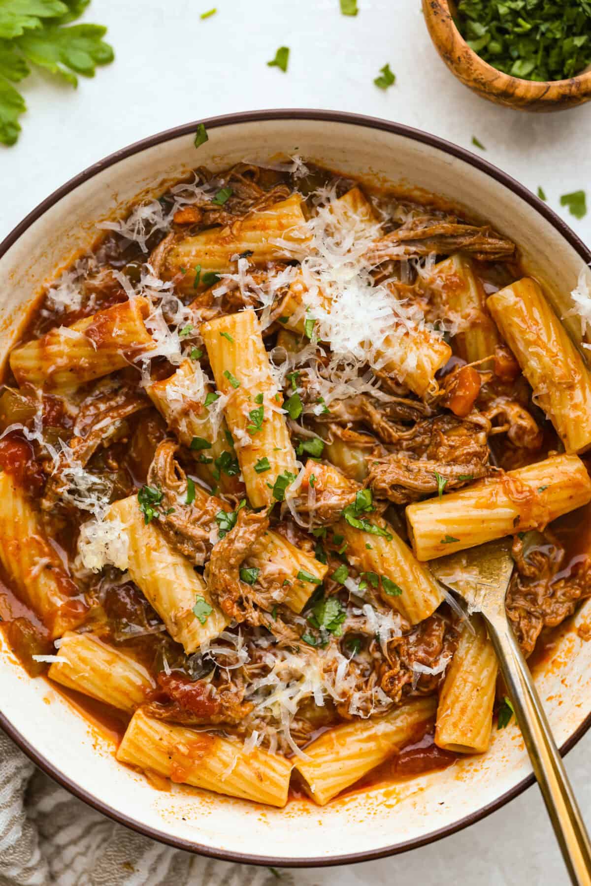 Bowl of slow cooker brisket Ragu over pasta. 