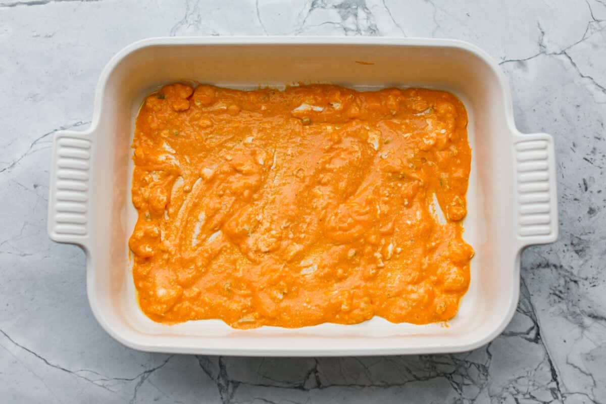 Part of the sauce spread across the bottom of the 9x13 baking dish. 