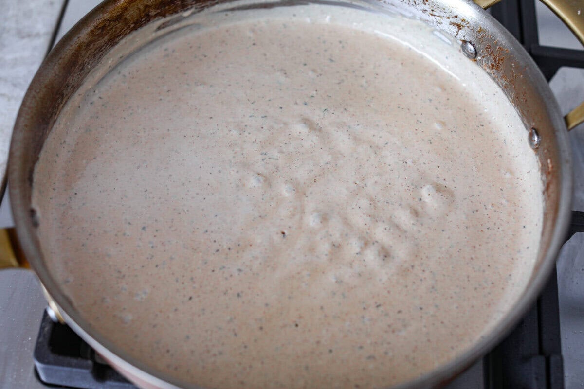 Adding the creamy Caesar sauce. 