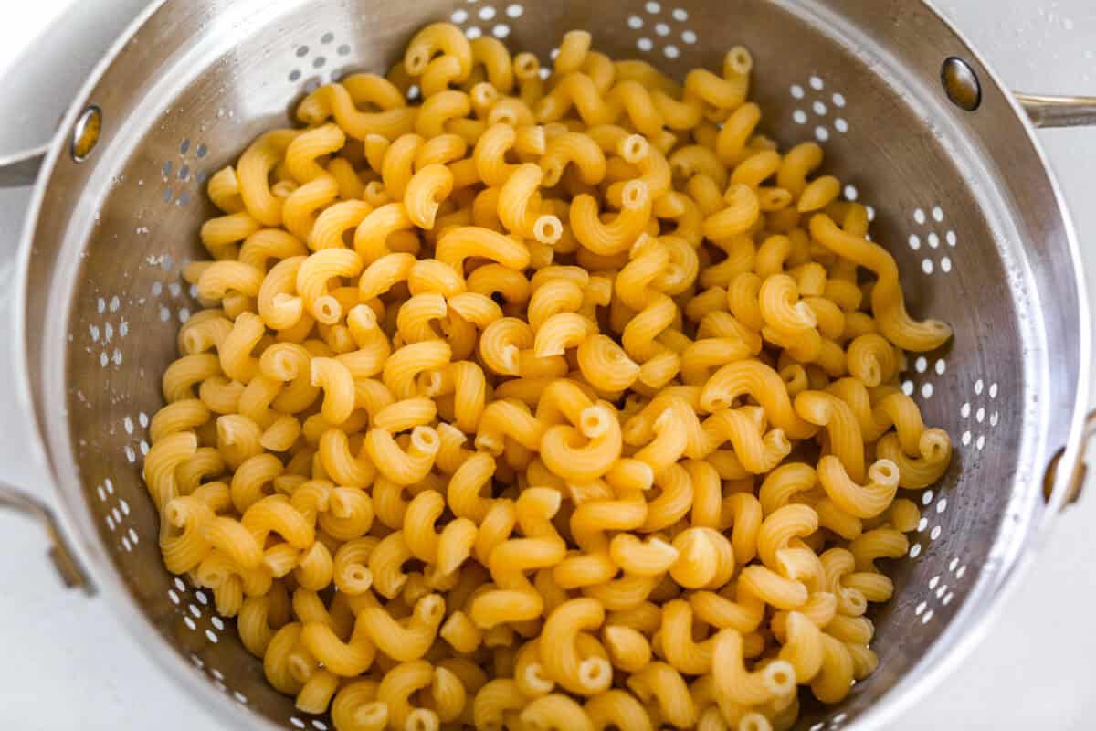 Pasta cooked and draining in a colander. 