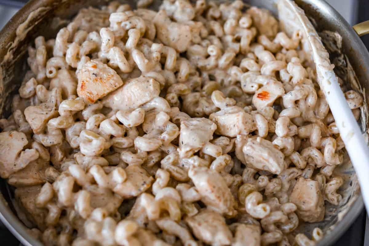 Chicken and pasta added to the skillet and stirred together. 