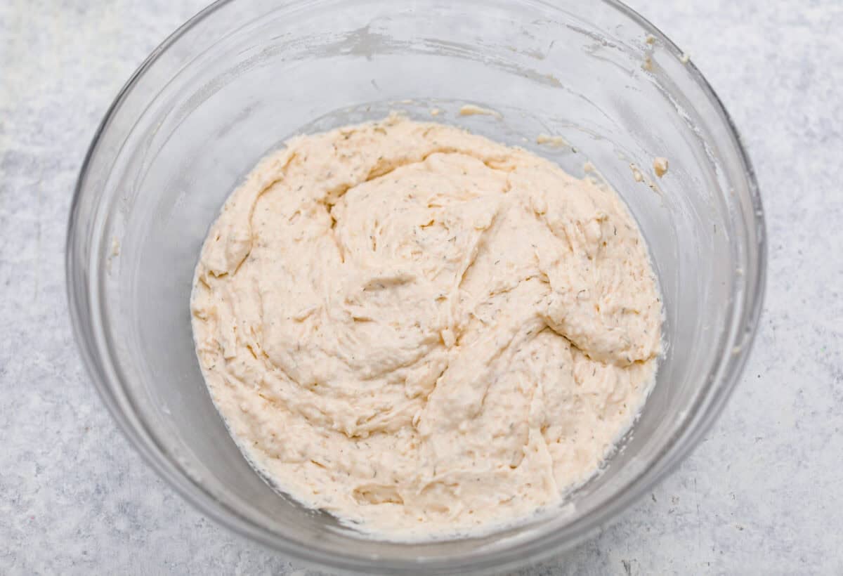 Dill pickle bread is cheesy, buttery, and packed with tangy pickle flavor in every bite. Chopped dill pickles and my secret dill pickle seasoning give this easy quick bread even more bold, briny flavor, with plenty of melty cheese. Dry and wet ingredients combined.