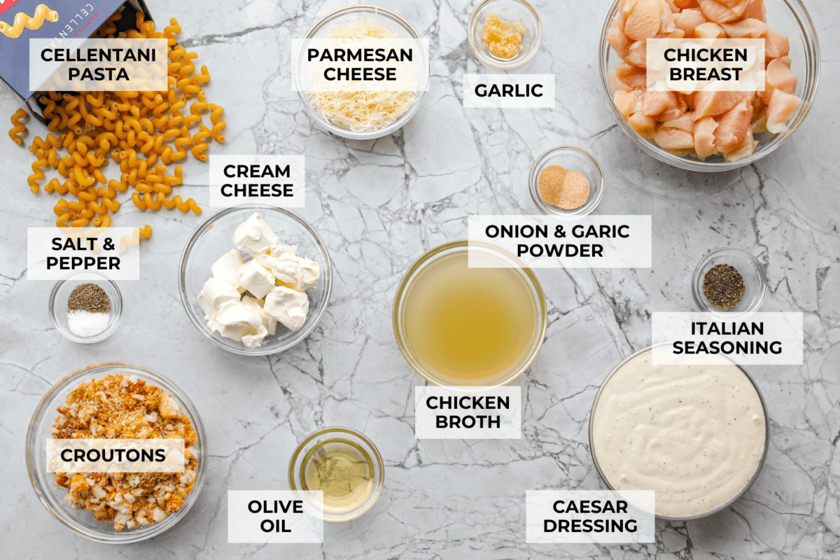 Overhead shot of labeled chicken caesar pasta ingredients. 