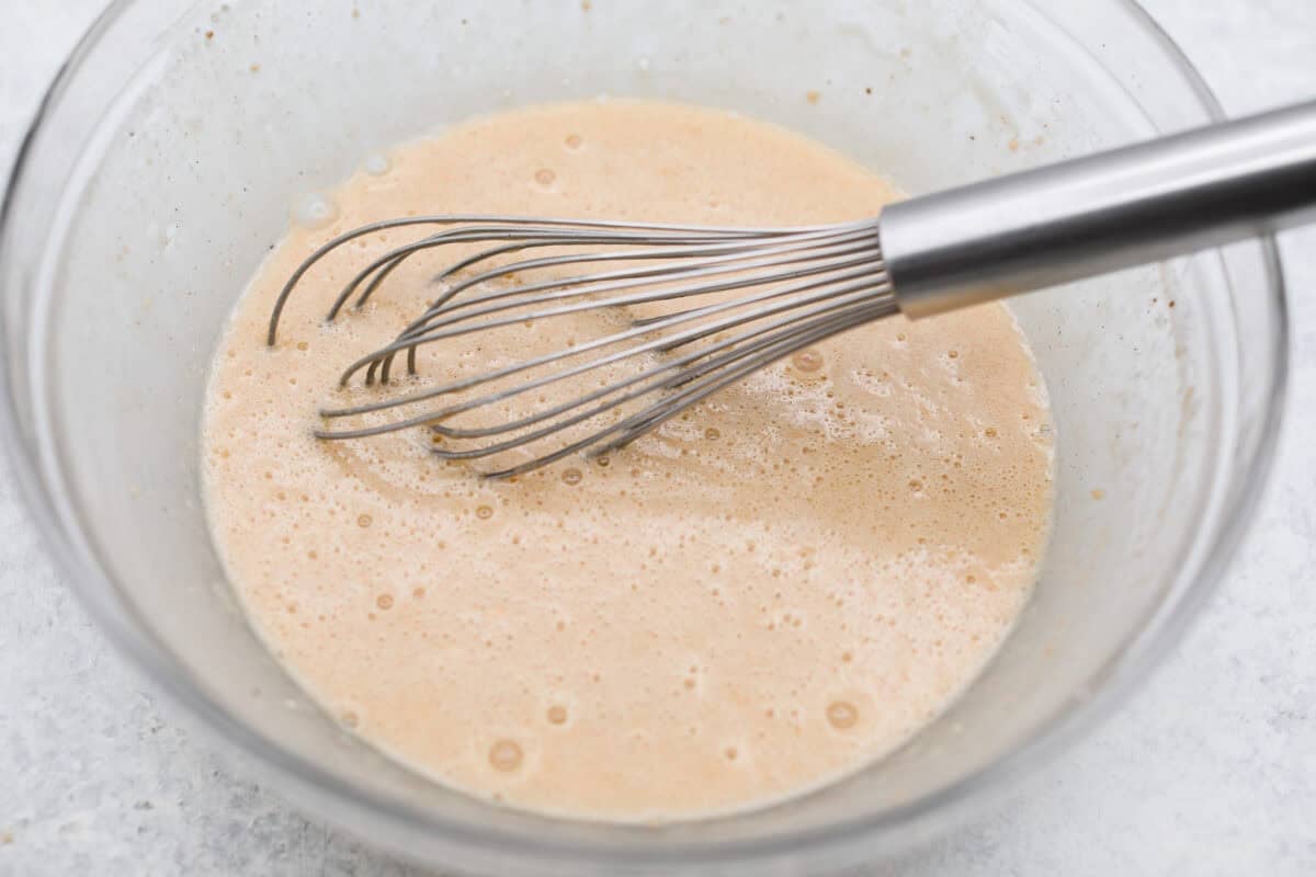 This invisible apple cake is a little magical! Paper-thin apple slices are coated in a simple, lightly spiced batter, then layered in a loaf pan and baked into a tender, custardy cake. Such a delicious way to enjoy fresh apples! Wet and dry ingredients combined.