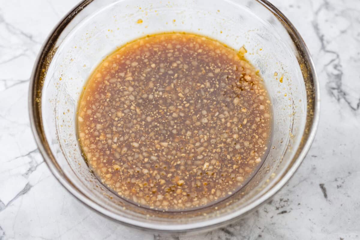 Maple glazed salmon has that perfect sweet-and-savory flavor that keeps you going back for just one more bite. As it bakes, the maple glaze turns glossy and caramelized while the salmon stays buttery, flaky, and melt-in-your-mouth tender. Maple glaze sauce ingredients whisked together in a bowl.