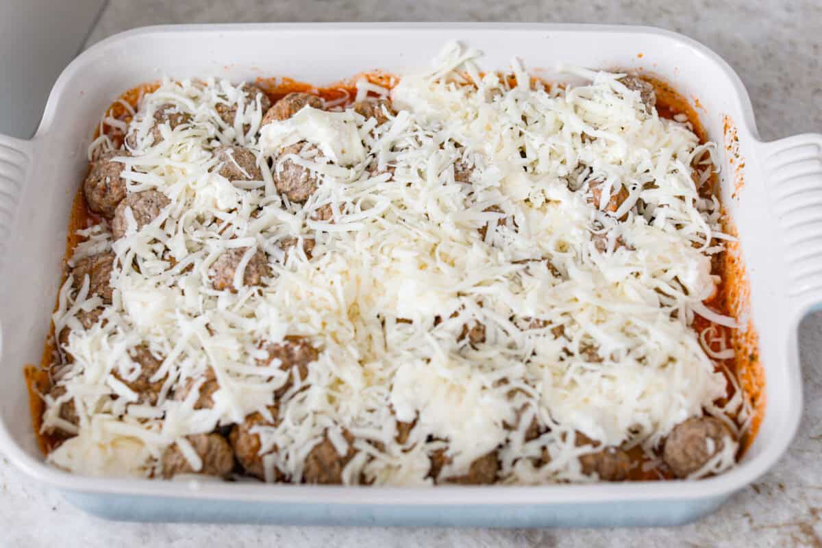 Cheese added to the top of the meatballs. 