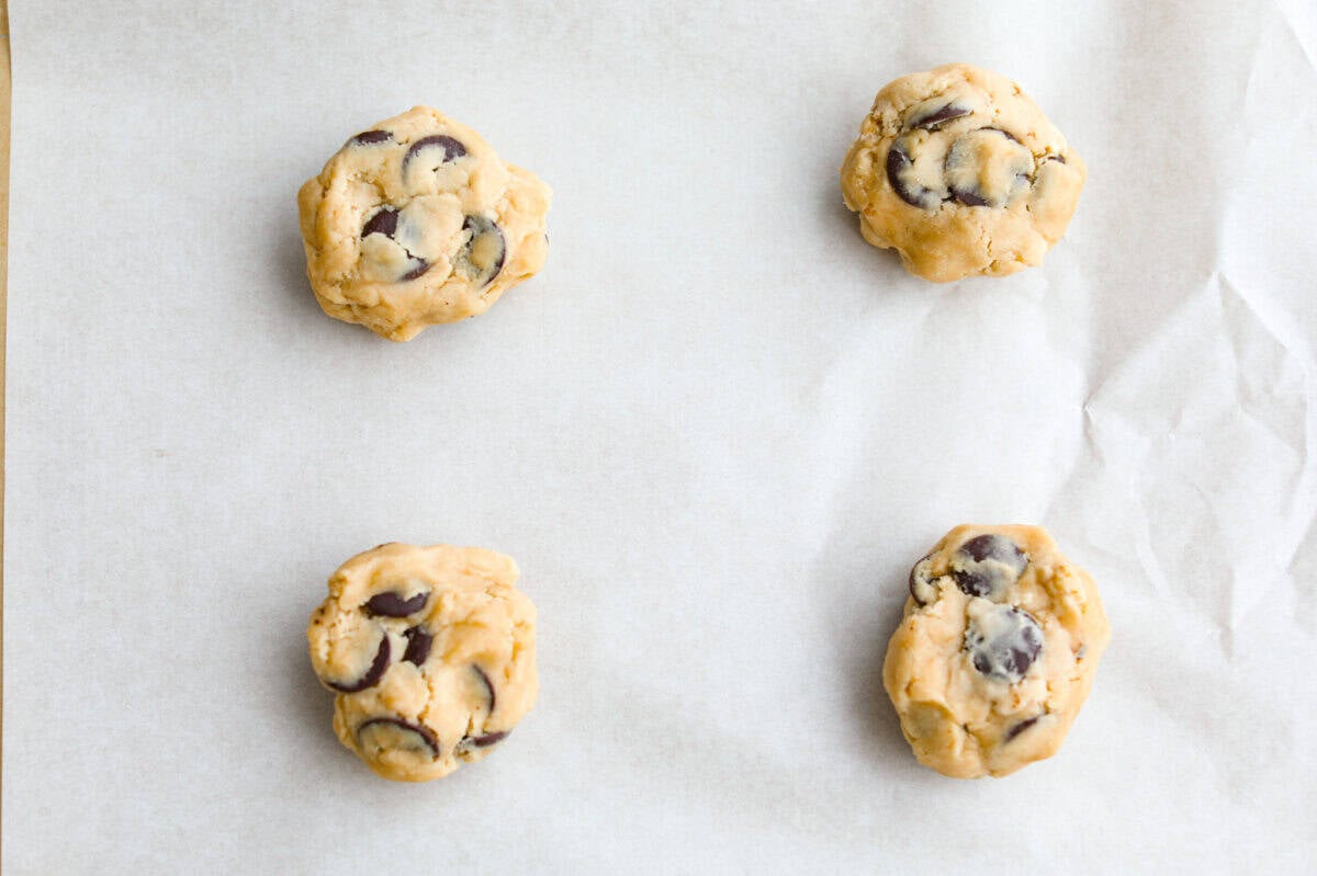 Jacques Torres Chocolate Chip Cookies come from the famous “Mr. Chocolate” himself. They were featured in The New York Times’ search for the perfect chocolate chip cookie. The secret is letting the dough rest before baking. It gives you crisp, buttery edges and chewy centers. Each cookie dough bal l place on the cookie sheet.