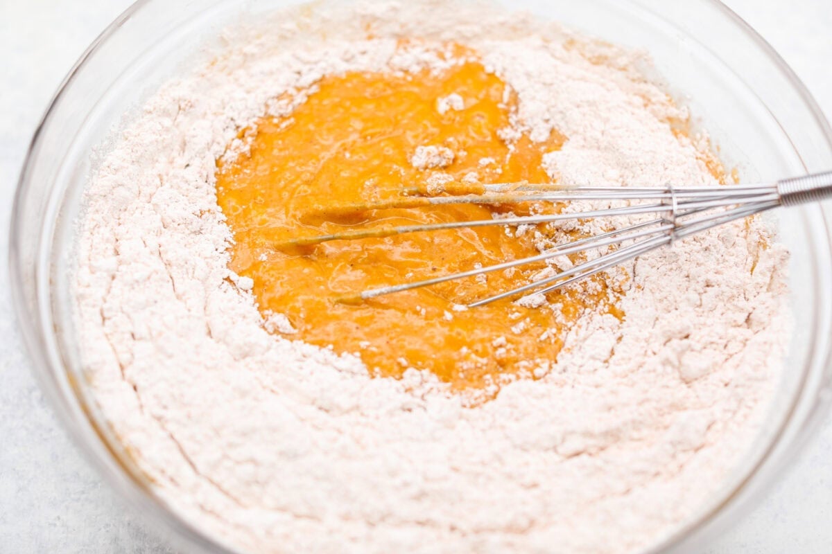 Someone whisking the wet and dry ingredients together. 