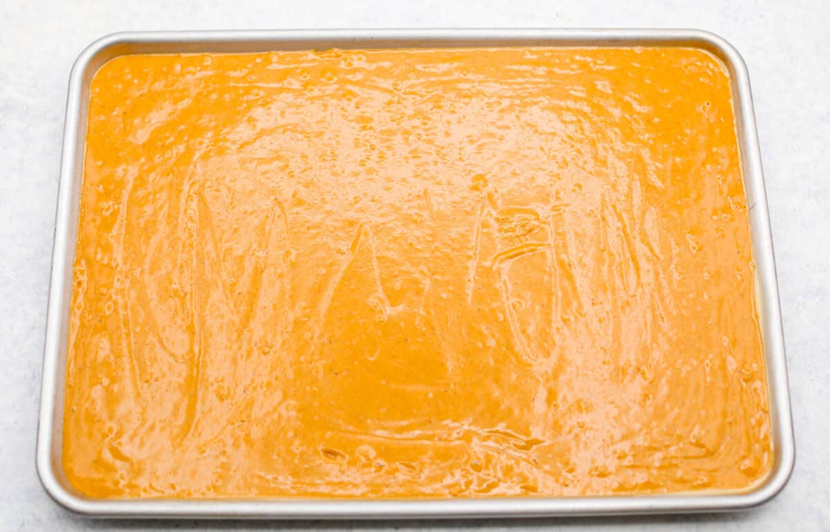 Batter poured into a jelly roll sheet pan read to be baked. 