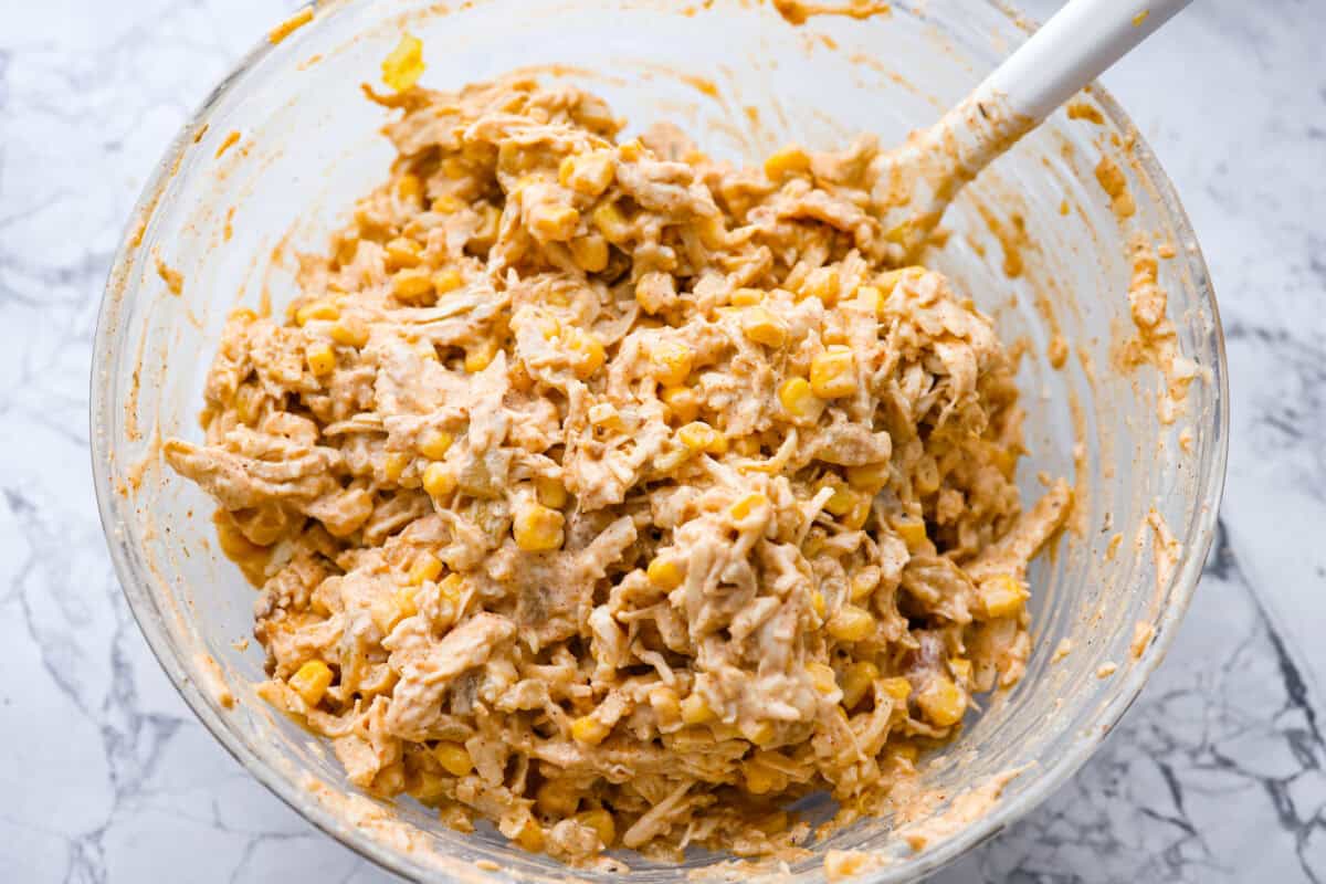 Chicken added, corn and cheese combined with some of the sauce. 