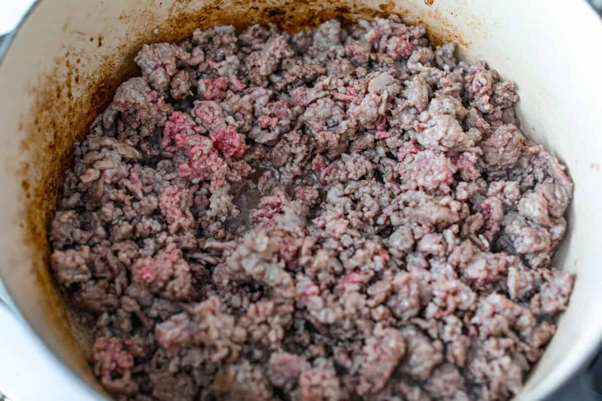 No tomatoes, no red sauce, just a rich, savory white bolognese loaded with beef, pork, bacon, white wine, and plenty of Parmesan. Tossed with noodles, it’s a fun and seriously delicious twist on classic Bolognese. Meat browning in a pot.